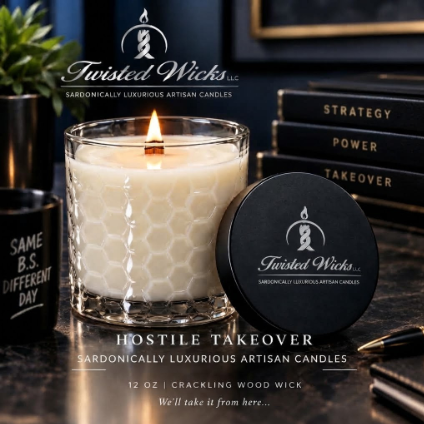 Hostile Takeover 12oz candle with a lit wood wick in a hexagon glass jar, black Twisted Wicks lid beside it on an executive desk