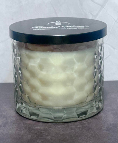 Sticky Situation 12oz artisan candle in a Hexagon patterned glass jar and a black lid featuring the 'Twisted Wicks' brand logo, set against a neutral gray background.